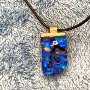 NWOT -contemporary iridescent resin one-of-a-kind pendant with black cord.